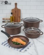 Falez 9-piece brown granite non-stick cookware set including deep pots, shallow casserole, and fry pan with glass lids, Made in Turkey, displayed on a marble kitchen counter.