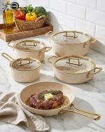 Falez 9-piece cream granite non-stick cookware set with gold handles, featuring a fry pan, sauce pan, and casseroles with glass lids, made in Turkey for healthy low-oil cooking.