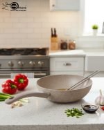 O.M.S. brown granite non-stick wok pan made in Turkey, displaying stir-fry cooking with 90% less oil and fresh ingredients on a kitchen counter.