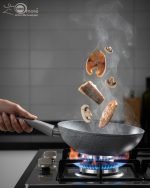 O.M.S. brown granite non-stick wok pan made in Turkey, displaying stir-fry cooking with 90% less oil and fresh ingredients on a kitchen counter.