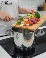 Falez 9-liter stainless steel pressure cooker with grey and red safety lid, sitting on a stovetop, featuring Turkish manufacturing quality – available at ONEMORE.