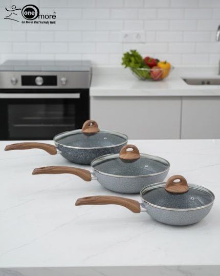 One More grey granite non-stick wok pan with a single long wooden-style handle, cooking shrimp and vegetables on a stove, displaying stone texture.