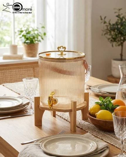 Elegant 5.5L ribbed glass beverage dispenser featuring a gold tap, leather handle, and heart-shaped gold lid knob, displayed on a wooden bamboo stand in a bright, modern dining setting.