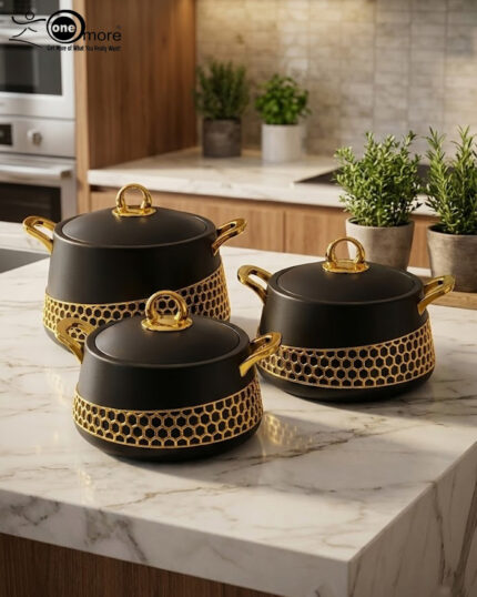 A luxury set of three insulated hotpot food warmers in matte black and white finishes featuring decorative gold hexagonal trim and polished gold handles, displayed in kitchen, dining, and outdoor settings.