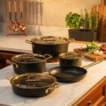 Falez 9-piece non-stick granite cookware set in black with gold handles, including fry pan, casserole, sauce pan, and pots with glass lids, made in Turkey.