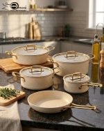 Falez 9-piece cream granite non-stick cookware set with gold handles, featuring a fry pan, sauce pan, and casseroles with glass lids, made in Turkey for healthy low-oil cooking.