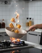 O.M.S. brown granite non-stick wok pan made in Turkey, displaying stir-fry cooking with 90% less oil and fresh ingredients on a kitchen counter.