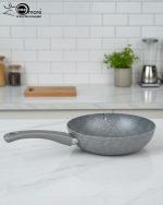 O.M.S. brown granite non-stick wok pan made in Turkey, displaying stir-fry cooking with 90% less oil and fresh ingredients on a kitchen counter.