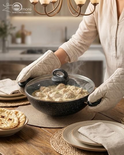 One More black granite non-stick wok set stacked in four sizes (24cm, 26cm, 28cm, 30cm) with glass lids and double handles, featuring a speckled texture for healthy low-oil cooking."