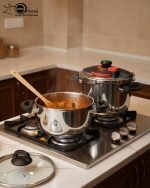 Falez stainless steel pressure cooker set including 6 liter and 9 liter pots with interchangeable pressure and glass lids, made in Turkey, displayed on a kitchen counter by One More.