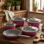 Falez 9-piece purple granite cookware set arranged on a kitchen counter, featuring non-stick deep pots, a shallow casserole with glass lids, and a frying pan with food cooking inside, Made in Turkey.