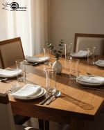 Pasabahce 7-piece clear glass water set featuring one jug and six glasses with elegant gold rims, displayed on a wooden dining table.