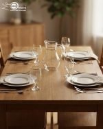 Pasabahce Turkish glass water set featuring 1 glass jug and 6 stemmed goblet glasses with elegant gold rims, arranged on a dining table.