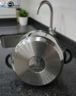 Falez 7 liter stainless steel pressure cooker made in Turkey placed on a kitchen stovetop with steam rising, featuring the ONEMORE brand logo.
