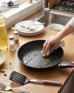 Stack of One More black granite non-stick cooking pots in four sizes (22cm, 24cm, 26cm, and 28cm) with ergonomic handles, displaying a premium speckled texture.