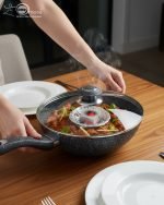 One More black granite non-stick wok pan with single long handle and glass lid, shown in 24cm and 30cm sizes, featuring a textured surface for low-oil stir frying.