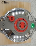 Falez 9-liter stainless steel pressure cooker with grey and red safety lid, sitting on a stovetop, featuring Turkish manufacturing quality – available at ONEMORE.