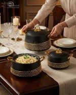 Three-piece luxury insulated hotpot set by One More in matte black and pearl white, featuring gold honeycomb lattice designs, gold handles, and steaming hot food in various dining settings.