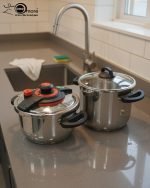 Falez stainless steel pressure cooker set including 6 liter and 9 liter pots with interchangeable pressure and glass lids, made in Turkey, displayed on a kitchen counter by One More.
