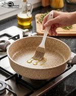 Falez non-stick granite shallow casserole set stacked in three sizes (26cm, 28cm, 30cm) with glass lids, featuring a speckled stone finish and brown handles for healthy low-oil cooking.