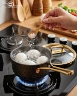 Falez 9-piece non-stick granite cookware set in black with gold handles, including fry pan, casserole, sauce pan, and pots with glass lids, made in Turkey.