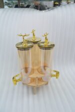 Triple 5.5L shaded glass beverage dispenser featuring gold deer-topped lids and gold taps, mounted on a 360-degree rotating wooden stand for elegant serving.
