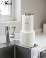 1-liter vacuum insulated thermos flask displaying three color options: green, white, and grey, standing side by side.