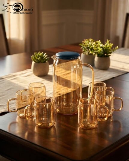 A 7-piece amber-tinted glass water set featuring a tall pitcher with a navy blue lid and six matching mugs arranged on a wooden table and a serving tray in a sunlit living room.