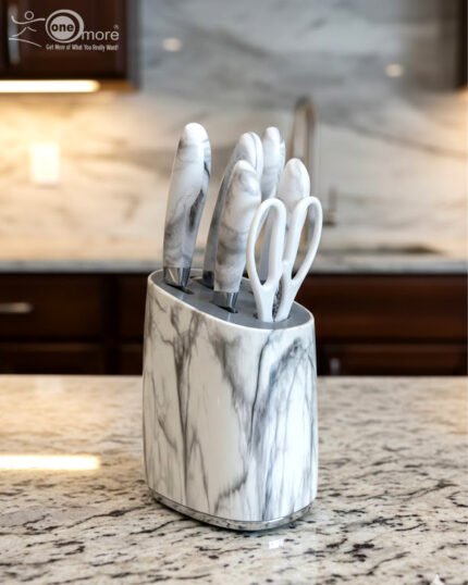 A 6-piece kitchen knife set featuring white and grey marble-patterned handles and a matching oval storage block, displayed on a granite countertop.
