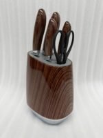 A 6-piece kitchen knife set featuring stainless steel blades with dark wood-grain patterned handles and a matching oval storage block on a granite countertop.