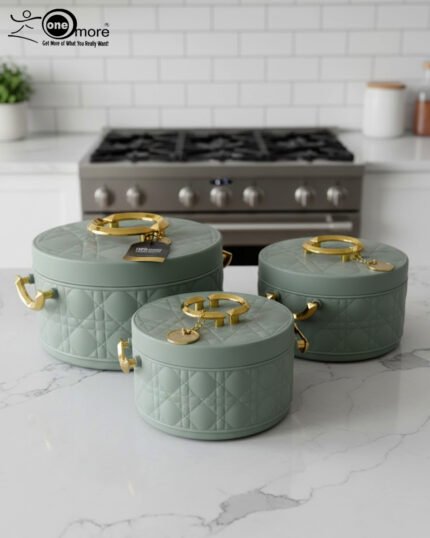 A set of three round, quilted insulated hotpots in varying sizes (1L, 2.5L, and 4L) with gold handles and lid accents, displayed on a kitchen counter and wooden dining table.