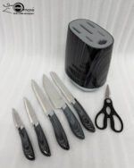 A professional 6-piece kitchen knife set featuring dark grey wood-grain patterned handles and a matching universal storage block, displayed on a white marble countertop with fresh lemons and herbs.