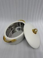 A set of three modern, oval-shaped insulated hotpots with gold handles and knobs, shown in chocolate brown, grey, and white colors on wooden and marble dining surfaces.