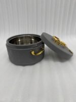 A set of three round, quilted insulated hotpots in varying sizes (1L, 2.5L, and 4L) with gold handles and lid accents, displayed on a kitchen counter and wooden dining table.