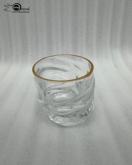 A set of six clear crystal drinking glasses featuring a unique twisted, rippled texture and a thin decorative gold rim on a neutral background.