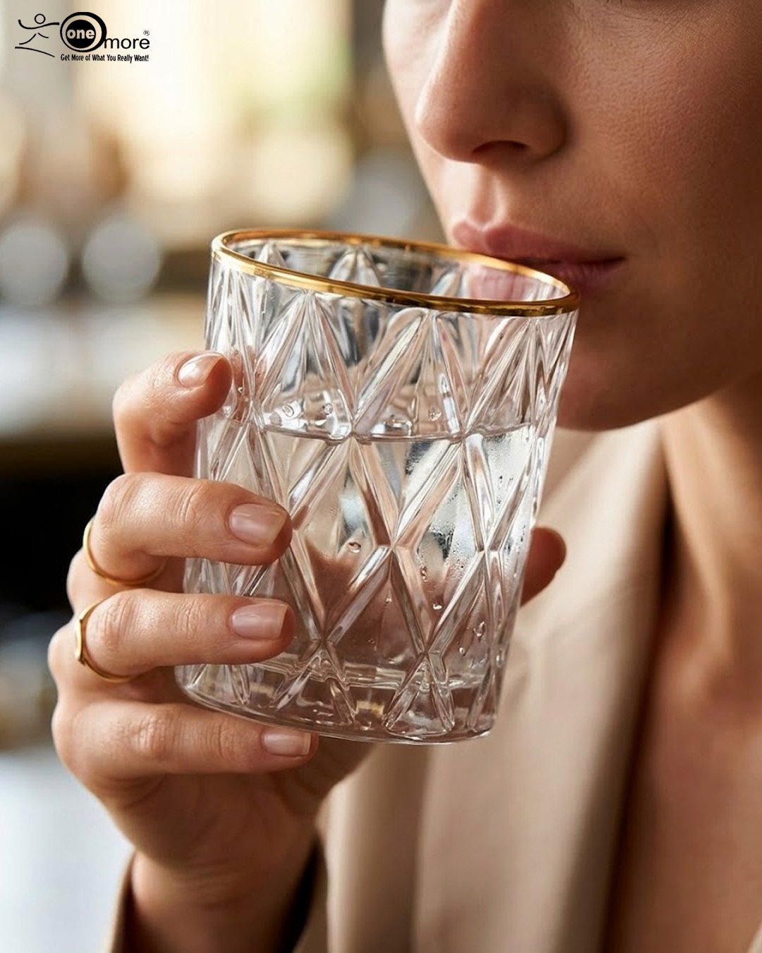 1 A set of six crystal-clear drinking glasses featuring a deep diamond-cut textured pattern and a thin, elegant gold metallic rim.