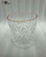 A set of six crystal-clear drinking glasses featuring a deep diamond-cut textured pattern and a thin, elegant gold metallic rim.