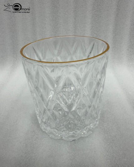 A set of six crystal-clear drinking glasses featuring a deep diamond-cut textured pattern and a thin, elegant gold metallic rim.