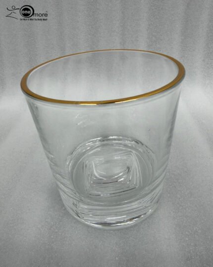 Close-up of a person drinking from a luxury RCR-inspired crystal glass with a gold-plated rim and heavy base, showcasing elegant tableware.