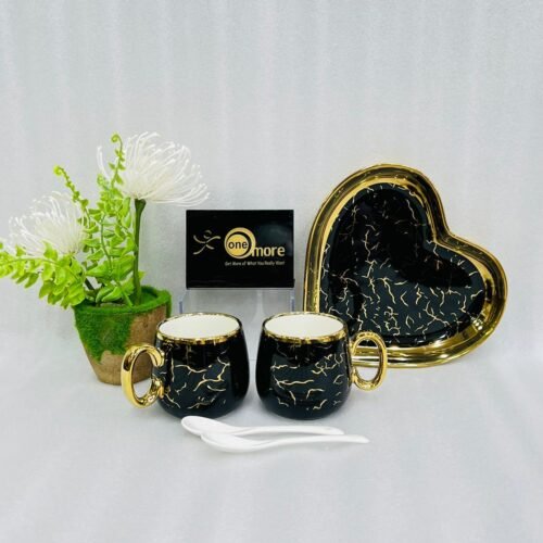 A luxury 5-piece stoneware coffee set for couples featuring two round marble-patterned mugs with gold handles, two white spoons, and a matching heart-shaped gold-rimmed tray, available in black, white, green, blue, and yellow.
