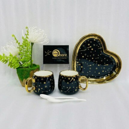 A 5-piece stoneware couple's coffee set featuring two star-patterned mugs with gold handles, two white spoons, and a matching gold-rimmed heart-shaped tray on a clean white background.