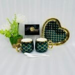 A luxury 5-piece stoneware coffee set for couples featuring two mugs with gold lattice patterns, a matching heart-shaped tray with gold trim, and two white spoons, available in multiple colors including black, green, and pink.