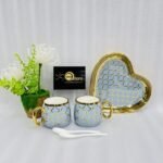A luxury 5-piece stoneware coffee set for couples featuring two mugs with gold lattice patterns, a matching heart-shaped tray with gold trim, and two white spoons, available in multiple colors including black, green, and pink.