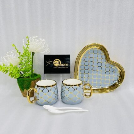 A luxury 5-piece stoneware coffee set for couples featuring two mugs with gold lattice patterns, a matching heart-shaped tray with gold trim, and two white spoons, available in multiple colors including black, green, and pink.