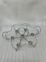 Paramount Series 7-in-1 buffet food warmer set featuring seven clear glass bowls with polished stainless steel lids and a silver metal stand with buffet burners on a decorated dining table.