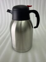 Stainless Steel Thermal Flask with a black lid and handle, available in 1.5 liter and 2 liter sizes, shown on a kitchen countertop.