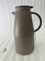 Three 2-liter luxury stainless steel thermal flasks in black, cream, and grey finishes with metallic handles, arranged on a white marble kitchen counter.