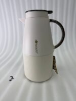 Three 2-liter luxury stainless steel thermal flasks in black, cream, and grey finishes with metallic handles, arranged on a white marble kitchen counter.