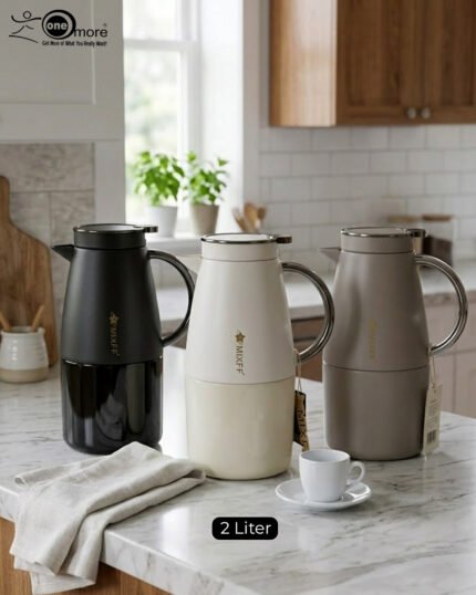 Three 2-liter luxury stainless steel thermal flasks in black, cream, and grey finishes with metallic handles, arranged on a white marble kitchen counter.