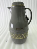 A trio of elegant 2-liter Feenik thermal flasks in cream, grey, and taupe featuring gold floral patterns on a marble kitchen countertop.